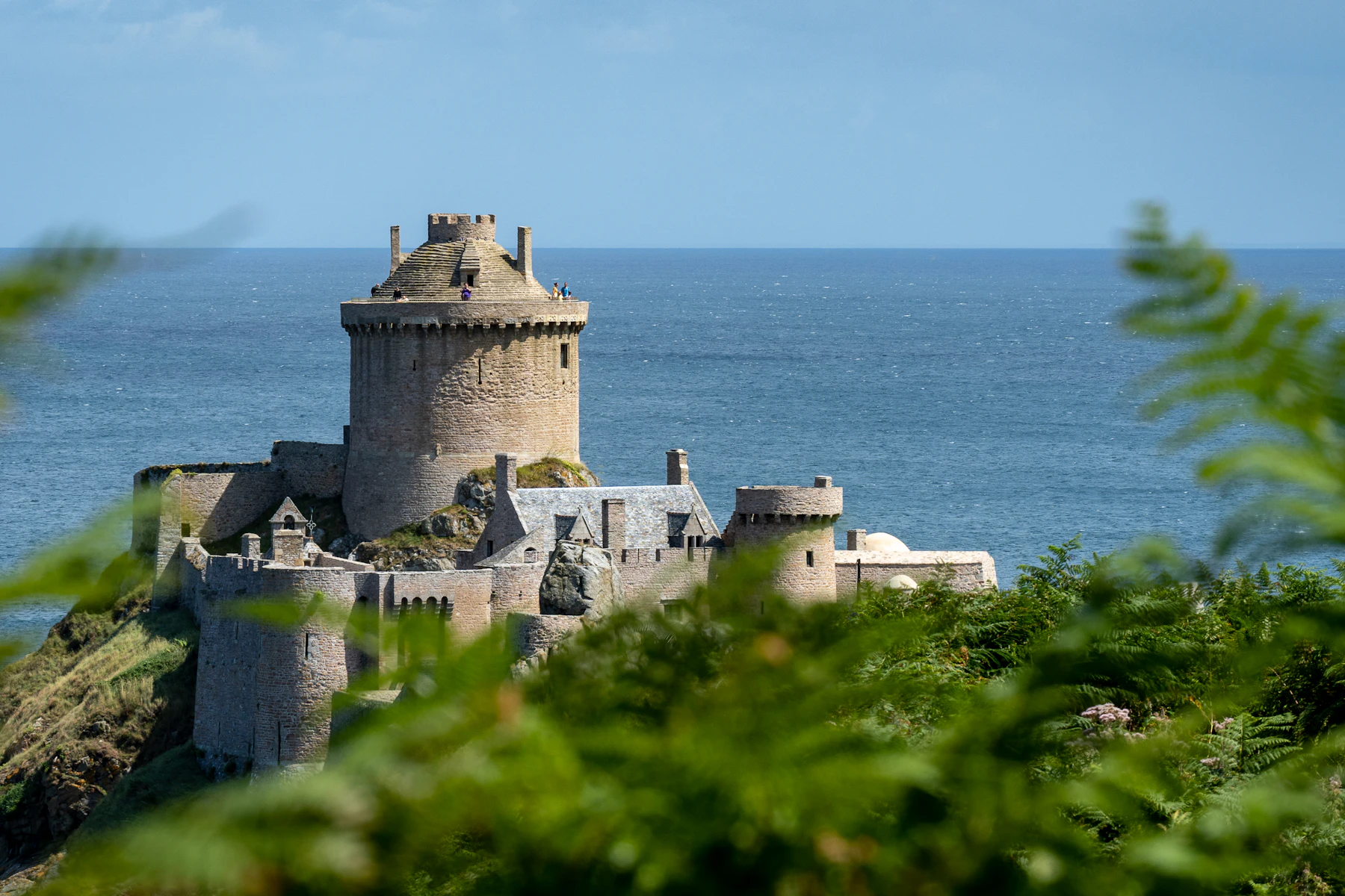 A stone tower on a rocky headland above the sea