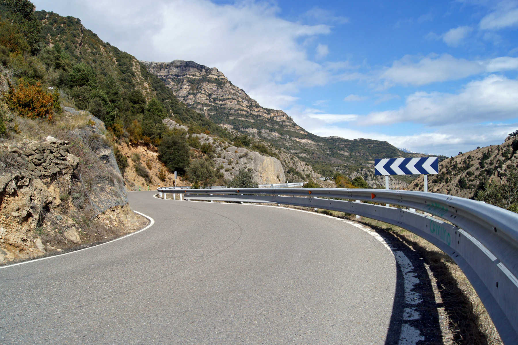 A road curving along a cliff high above the sea